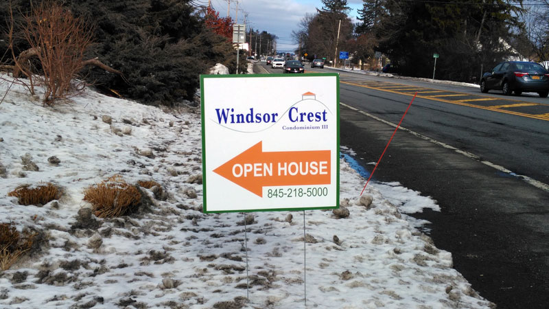 Picture of an open house sign outside on State Route 32 at the entrance of Windsor Crest at Highwood Drive